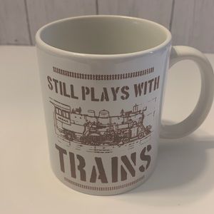 Still Plays With Trains coffee mug.